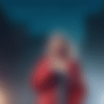 Create an image of Taylor Swift standing on a rainy stage in Scotland, wearing a stylish raincoat over her iconic Eras Tour outfit. She's holding a microphone and smiling at the crowd, while the audie